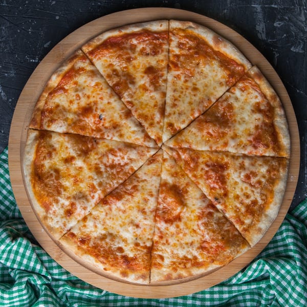 A SUPPA'S PIZZA & SUBS cheese pizza, cut into eight slices, on a wooden board.